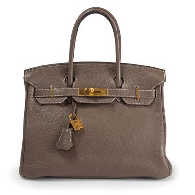 a brown leather handbag with a lock on the handle