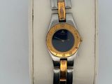 an image of a gold and silver wrist watch with a blue face
