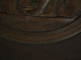 a bronze statue of a man with a hat on it