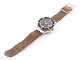 a close up of a watch on a white surface with a white background