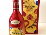 bottles of hennessy and a box of chocolates on a table