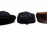 three hats are lined up on top of each other on a white surface