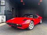 a red sports car parked inside of a garage