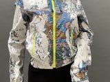 an image of a mannequin wearing a colorful jacket and black leggings