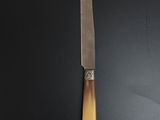 a picture of a knife on a black surface
