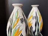 two vases that are sitting on a glass table