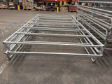 several metal frames are stacked on top of each other in a warehouse