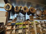 many hats hanging from the ceiling in a room