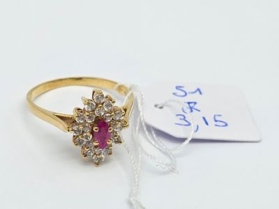 a close up of a gold ring with a pink stone