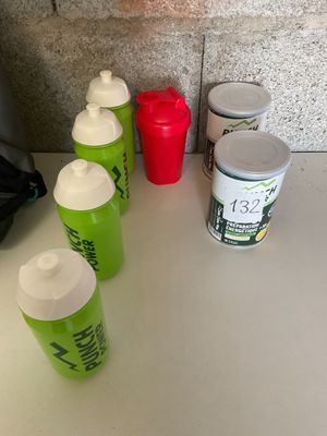 many cups of water sitting on the counter next to each other