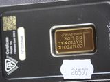 a close up of a gold bar in a black case