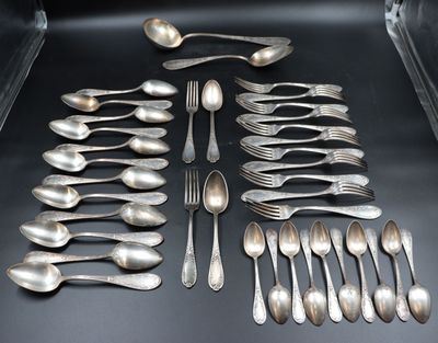 a lot of silver spoons and spoons on the table