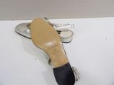 pair of silver and black shoes on a white surface