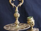 an antique brass candle holder with three candles on it