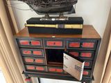a small cabinet with a pirate ship on top of it