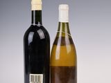 two bottles of wine sitting next to each other on a table
