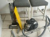 deux chaises et un aspirateur posés par terre dans une pièce