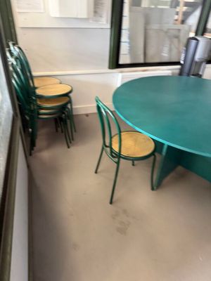 a table and chairs in a room with a large window