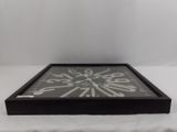 a black and white clock sitting on a white table