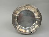 silver plate on stand on grey background with white background