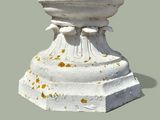 a white pedestal with a bird on top of it