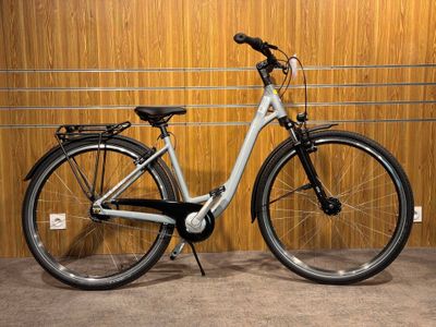 a bicycle that is parked in front of a wooden wall
