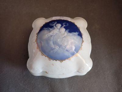 a white and blue bowl with a picture of a man on it