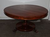 a round table with a wooden top in a room