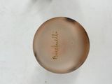 a small glass vase with a name written on it