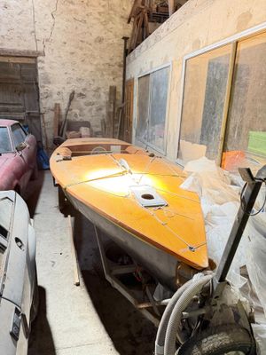 a boat and a car in a garage next to each other