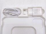 a white box with a charger and a cord in it