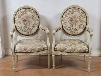 pair of french louis xvi style armchairs with floral upholstered upholstered cushions