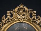 a gold frame with a picture of a man and a woman on it