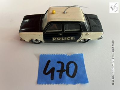 une petite voiture de police en jouet posée à côté d'une feuille de papier sur une table