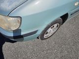 a blue car that is parked on the side of the road