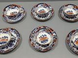 six tasses et une soucoupe posées sur une table