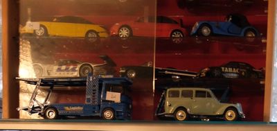 de nombreuses petites voitures dans une vitrine posée sur une étagère