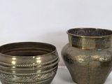 three silver vases sitting next to each other on a table