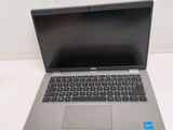 an open laptop computer sitting on top of a white table