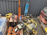 a pile of tools on a pallet in front of a building