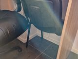 a desk with a chair and a computer on it