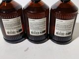 three bottles of alcohol sitting on top of a white table
