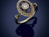 a gold and diamond ring, by person