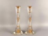 pair of clear glass vases with gold designs on the sides