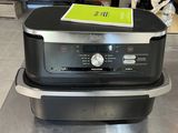 a black and silver oven sitting on top of a counter