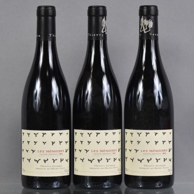 three bottles of wine sitting on top of a table next to each other