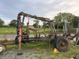 a tractor that is sitting in the grass near a fence