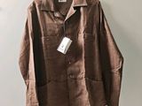 an image of a brown jacket hanging on a hanger
