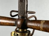a close up view of a brass fire hydrant with a wooden handle