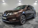 the front of a brown nissan suv parked on a checkered floor